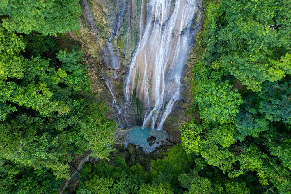 Aerial view of a waterfall in the Jamaican rainforest